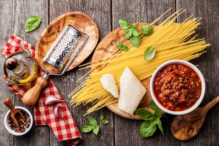 07 Dec 2014 --- Ingredients for spaghetti bolognese on gray wooden background --- Image by © Lisovskaya Natalia/The Picture Pantry/Corbis